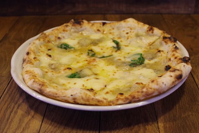 Pizzeria Tuka: Wood-Fired Pizza in a Log Cabin
